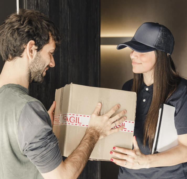 Young Female Courier Delivering Parcel to Man